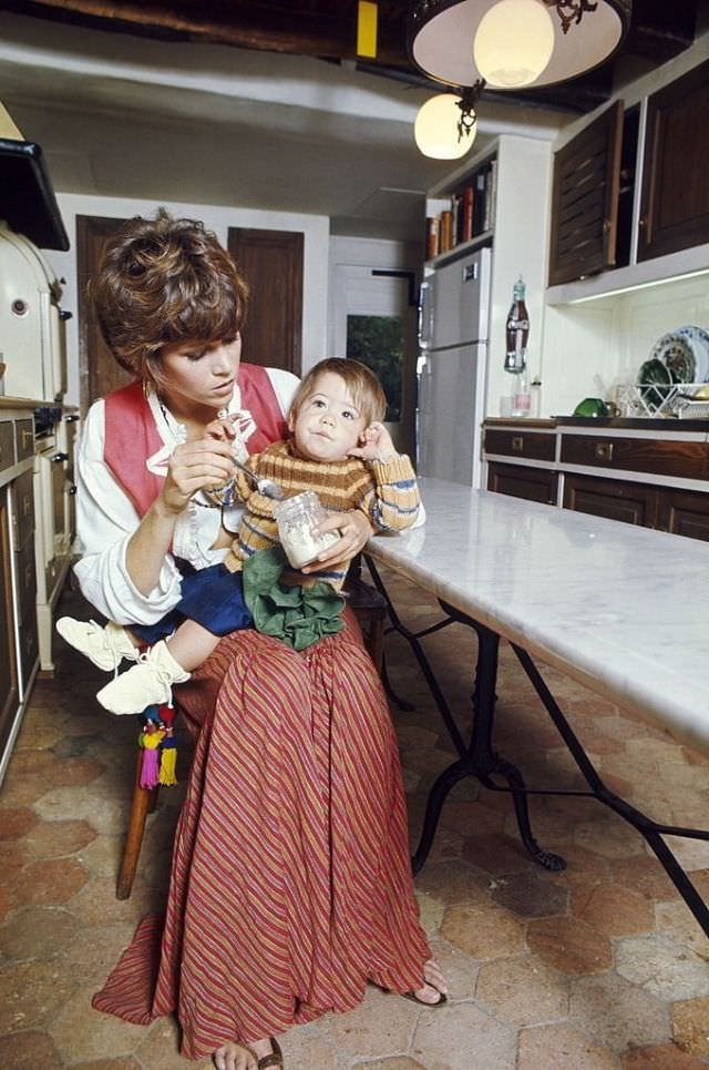 Jane Fonda feeding her daughter Vanessa yogurt in the kitchen of their home