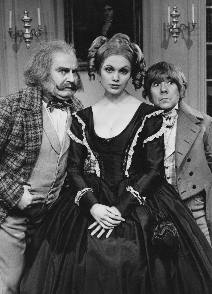 Madeline Smith with Ronnie Barker and Ronnie Corbett, wearing period costume in the ‘classic serial’ sketch from the television comedy series ‘The Two Ronnies’, 1971