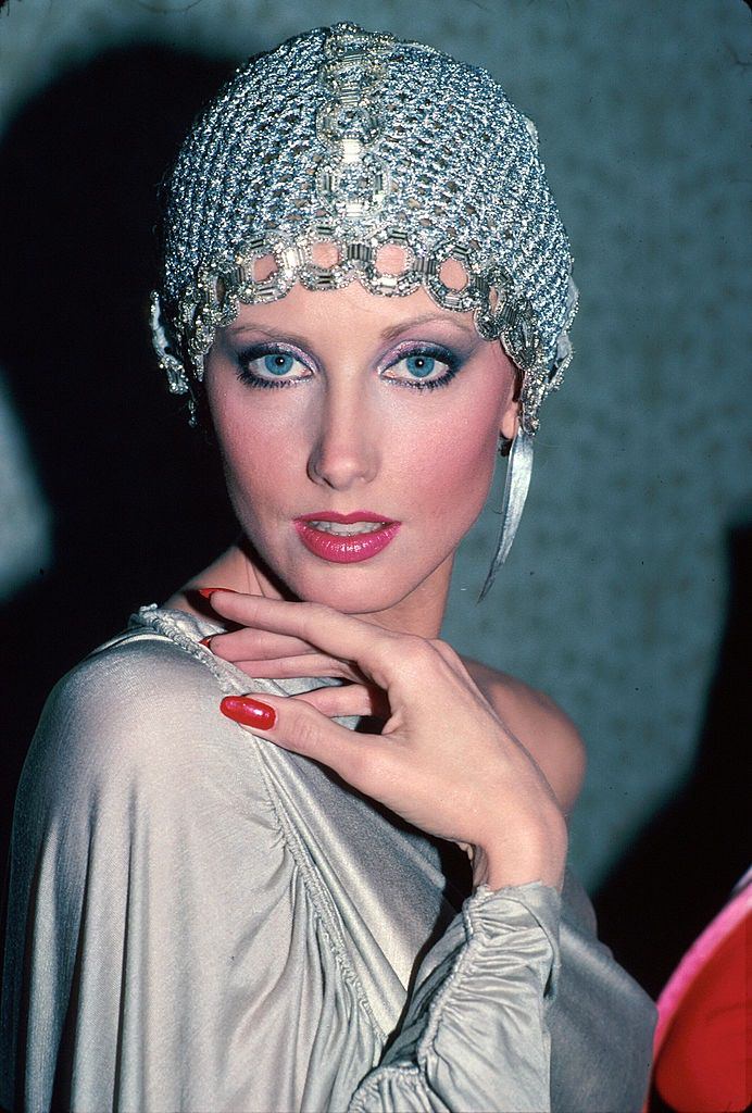 #17 Actress Morgan Fairchild wearing mesh hat