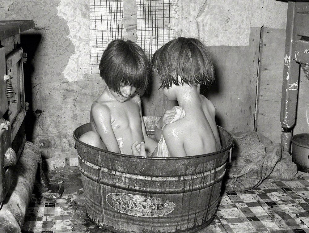 #15 Children taking bath in their home in May Avenue community camp, Oklahoma City, July 1939