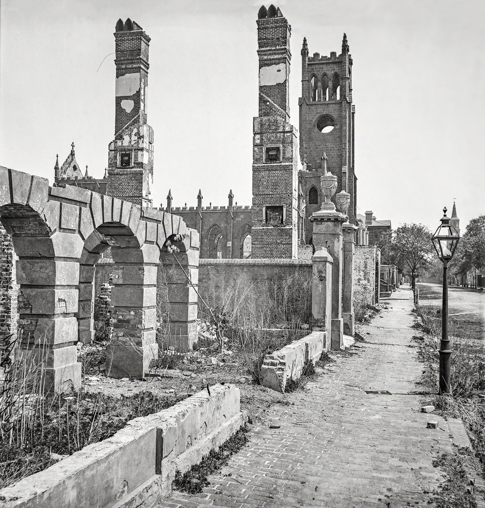 #47 Broad Street, looking east with the ruins of Cathedral of St. John and St. Finbar, Charleston 1865