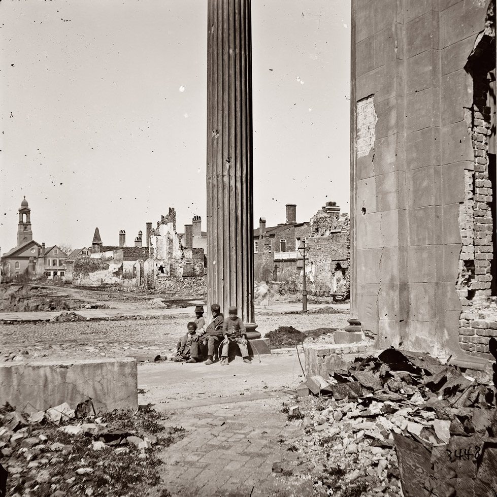 #62 View of ruined buildings through porch of the Circular Church at 150 Meeting Street, Charleston, April 1865