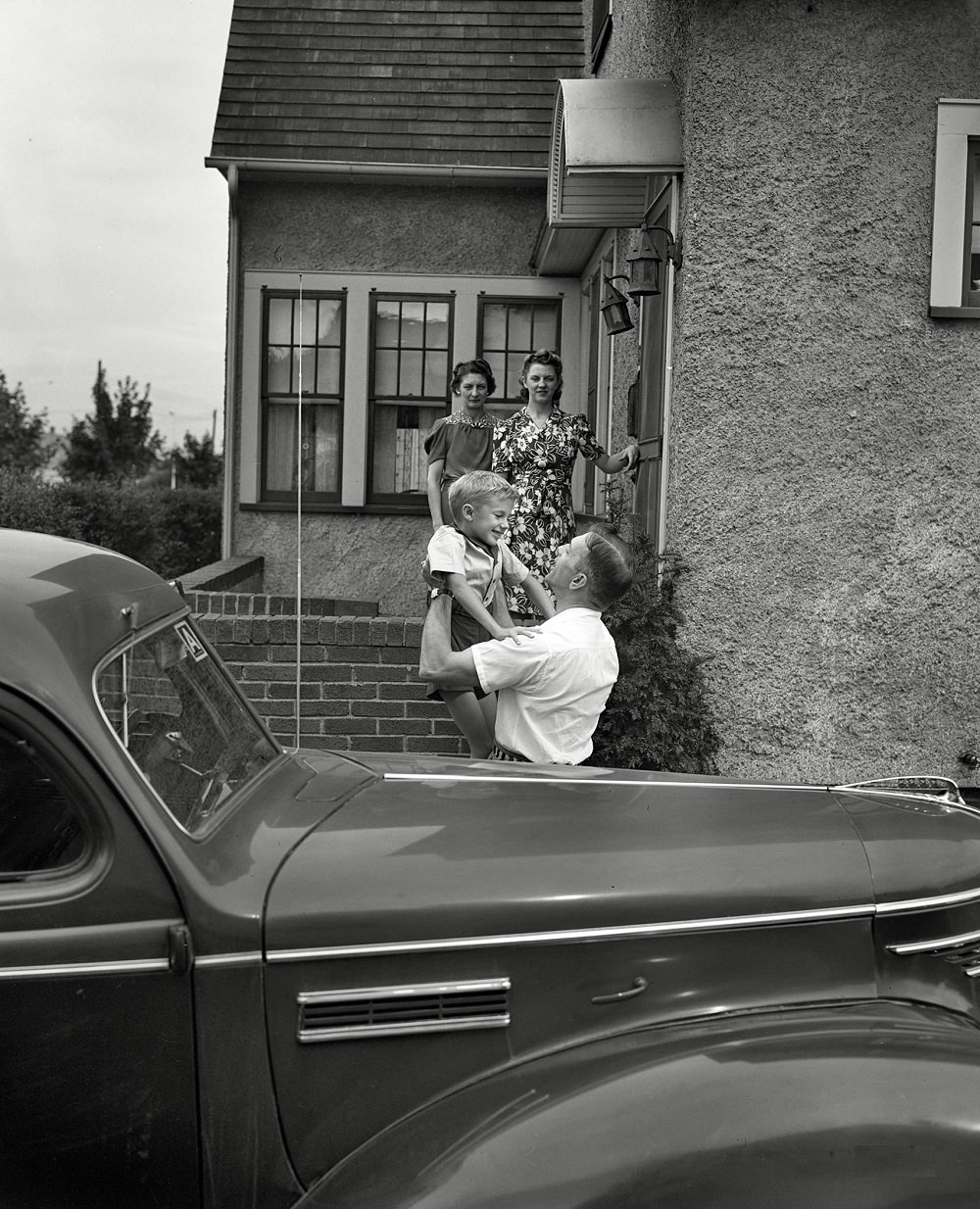 #20 Babcock, Shirley and Earl greeting Mr. Babcock in front of the house, New York, September 1942