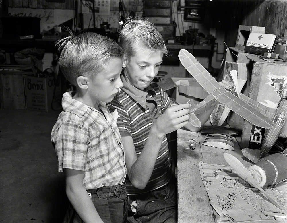 #22 Earl and Howard Babcock looking over one of the model airplanes which Howard built, New York, September 1942