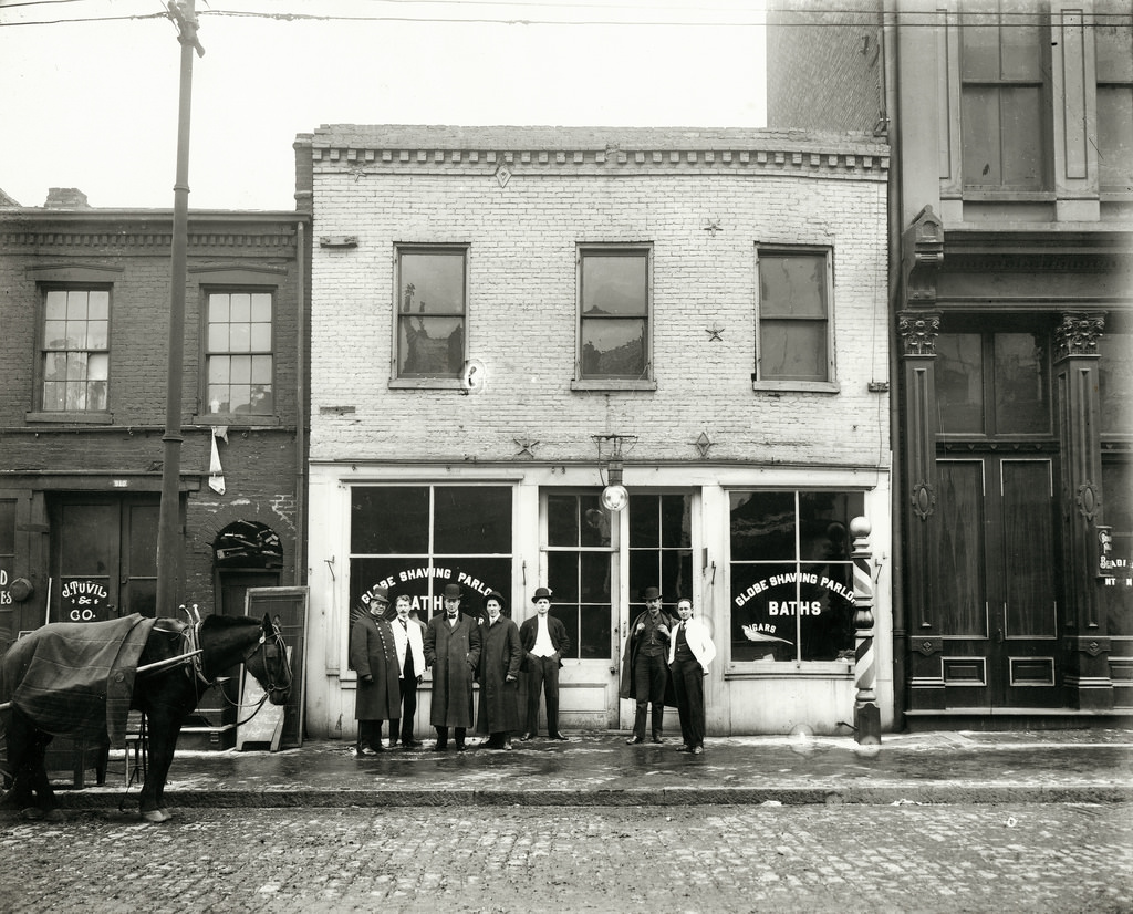 #49 Group of men standing in front of the Globe Shaving Parlor at 1015 Carr, 1910