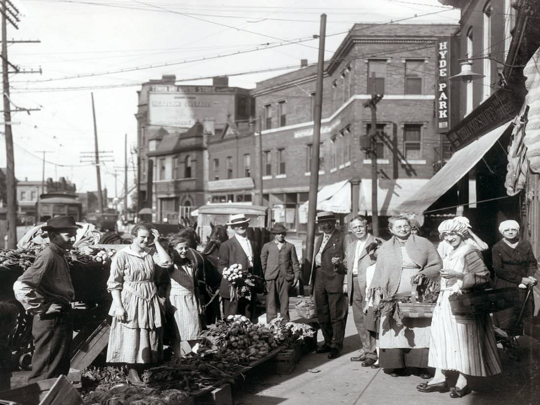 #27 Shoppers gathered by sidewalk produce outside the Theodore Prieshoff Grocery, 1929