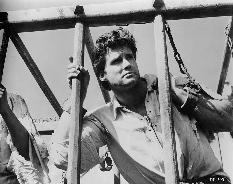 Steve Reeves shackled to bars in a scene from the film ‘Morgan The Pirate’, 1960