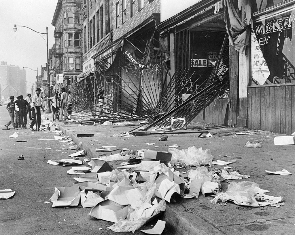 #49 Heavy metal gratings which failed to protect shop windows during the race riots in Detroit. The rioters later burned the shops they had looted, 1967