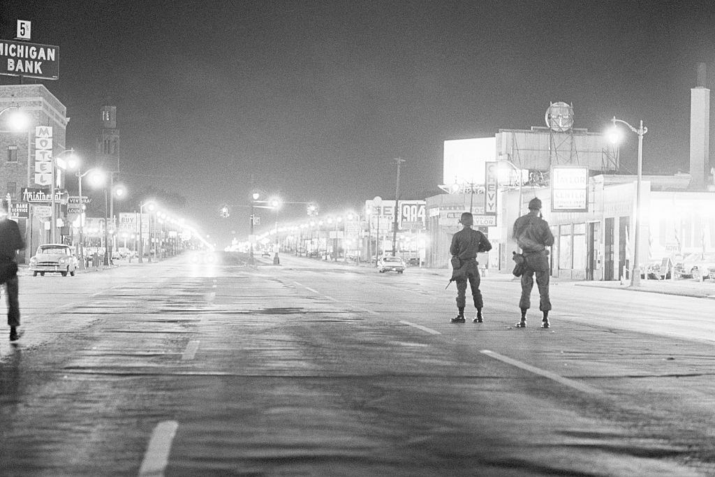 #47 Soldiers patrol a street on Detroit’s west side during a period of severe racial rioting, 1967
