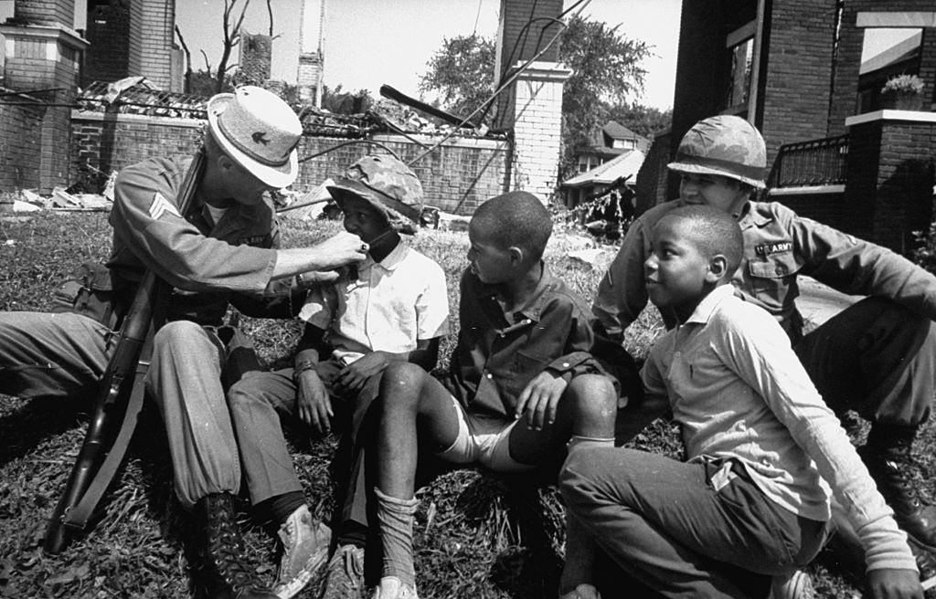 #16 Aftermath of Detroit race riots, National Guard having good time with kids, 1967