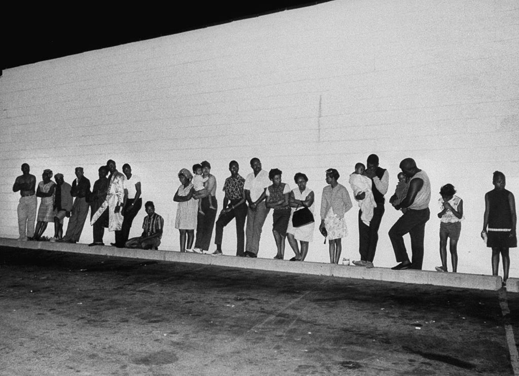#21 Police evacuate apartment building in search of sniper suspects, during riots, 1967