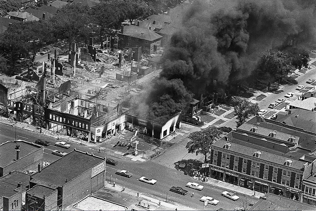 #36 The gutted remins of buildings (left) attest to the destruction caused by two days of rioting in Detroit’s west side, 1967