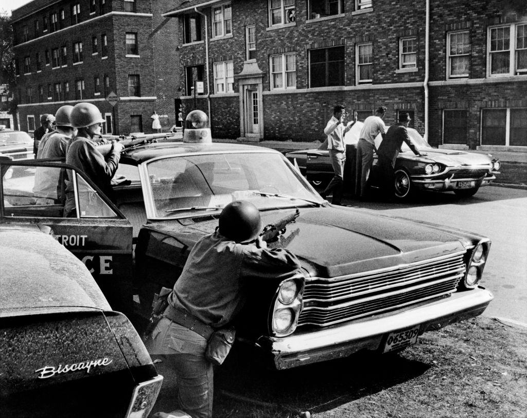 #40 Policemen arrest suspects in a Detroit street on July 25, 1967 during riots that erupted in Detroit following a police operation.