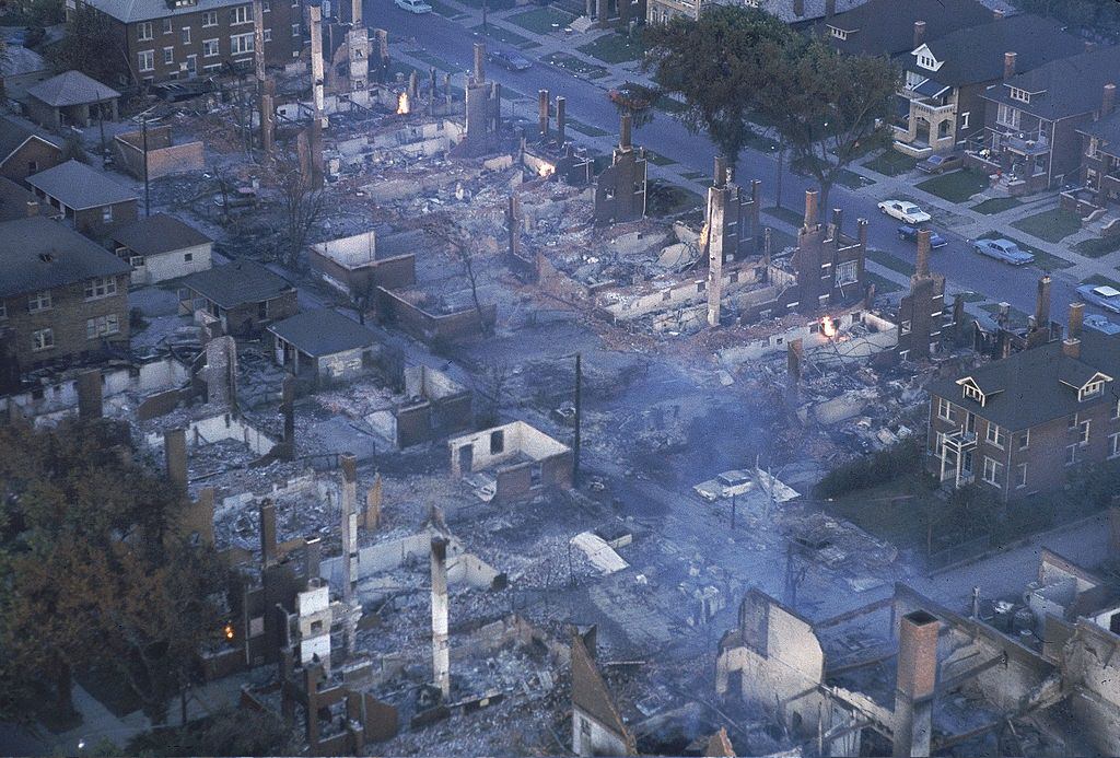 #7 Smoke lifting from burnt out buildings in aftermath of race riots, 1967