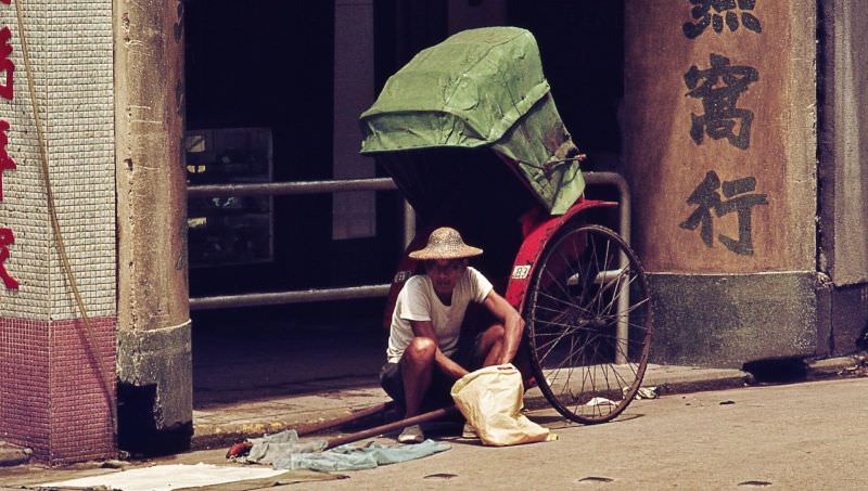 #56 Man sitting by his rickshaw, 1970s