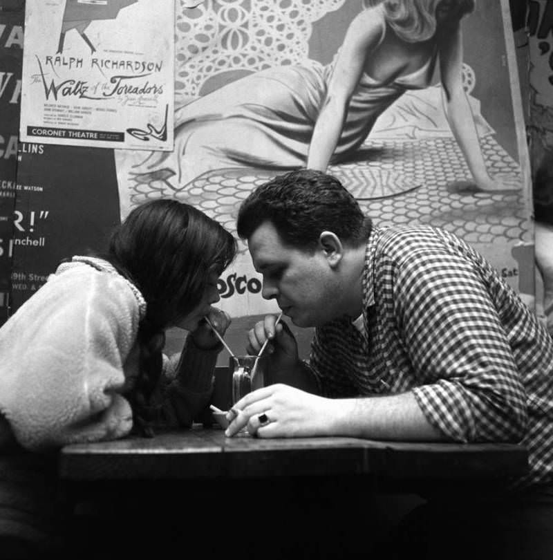 #25 A couple share a soda at the Cock N’ Bull on Bleecker Street in 1959.