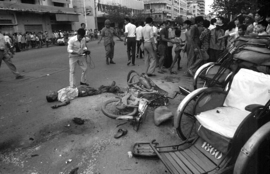 #17 A crowd gathers around a civilian killed by the Khmer Rouge, Phnom Penh. 1975.