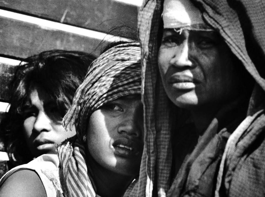#52 A group of women huddle together, 1975.