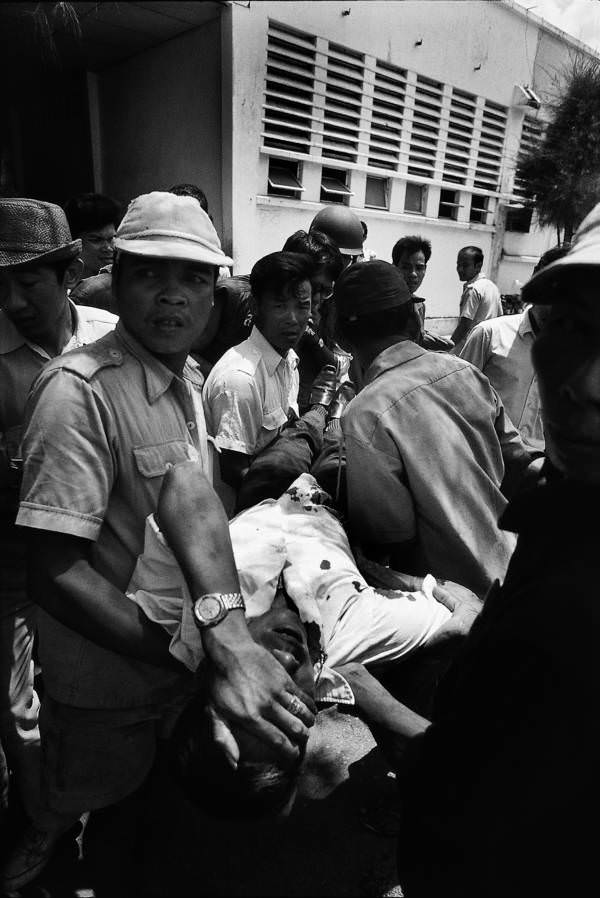 #26 Cambodians helping an injured civilian, Phnom Penh, 1975.
