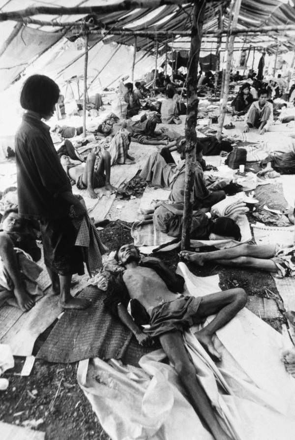 #31 Starving refugees get help from a Thai relief mission, laying in tents near the border, Pailin, Cambodia, 1979