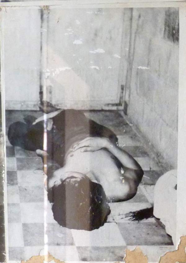 #33 A dead man’s body lies on the ground at Tuol Sleng, following his murder by the Khmer Rouge.