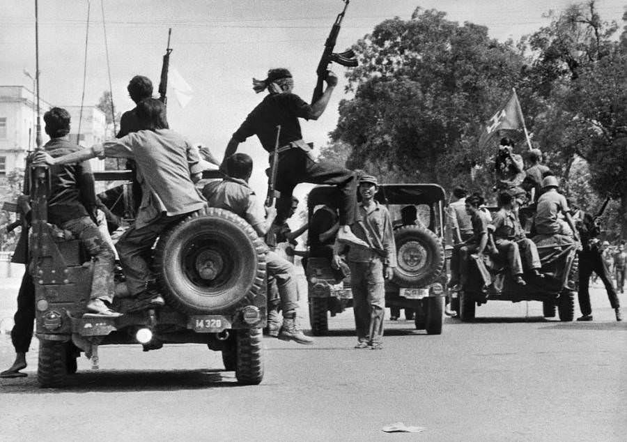 #4 Khmer Rouge soldiers drive through the capital, Phnom Penh. 1975.