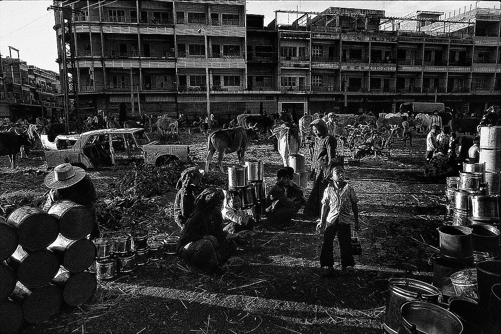 #48 The Fall of Phnom Penh. A group of people who found shelter next to an abandoned market area in the city center.