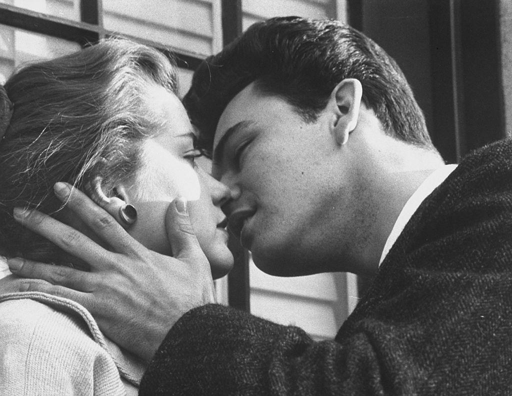 #22 Singer Rod Lauren kissing Delores Hart during screen test, 1960