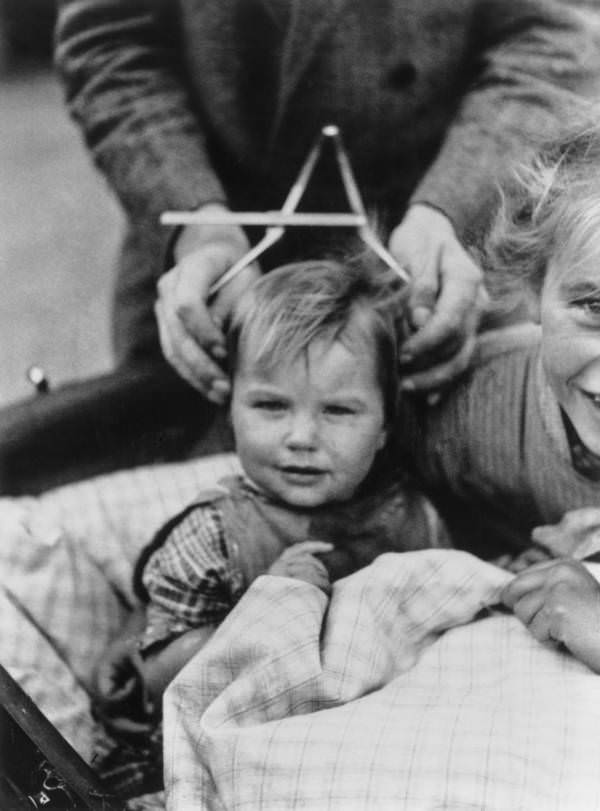 A child’s head is measured to determine his personality and predict his future in Schleswig-Holstein, Germany, in 1932.
