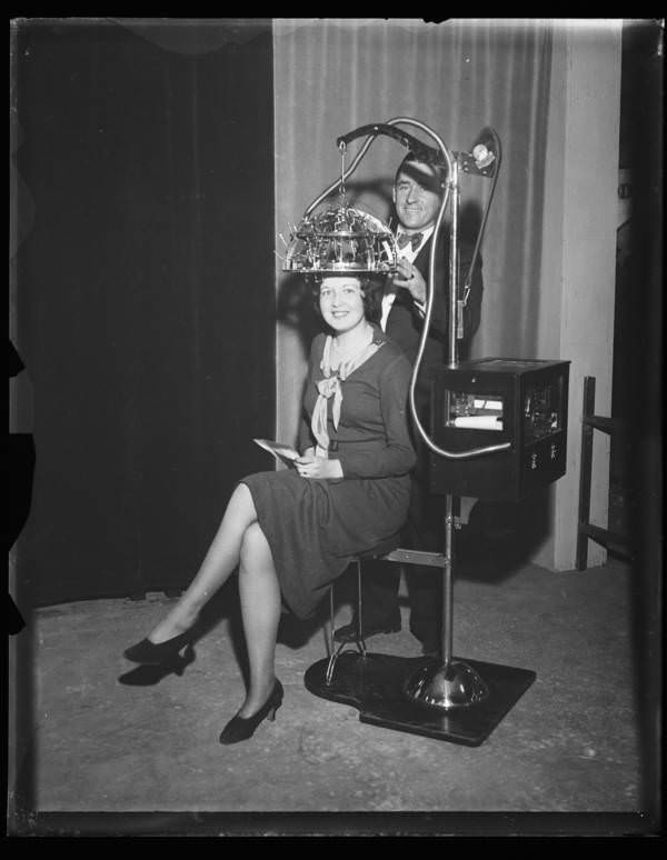 A woman wearing a psychograph, a machine designed to determine someone’s mental faculties by measuring their skull, America, 1931