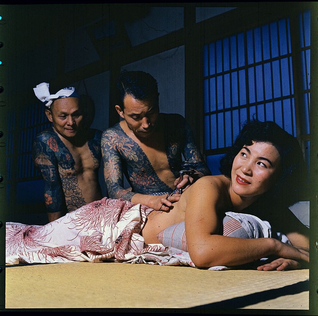 #13 Woman getting tattoo from Tokumitsu Uchida, 1900