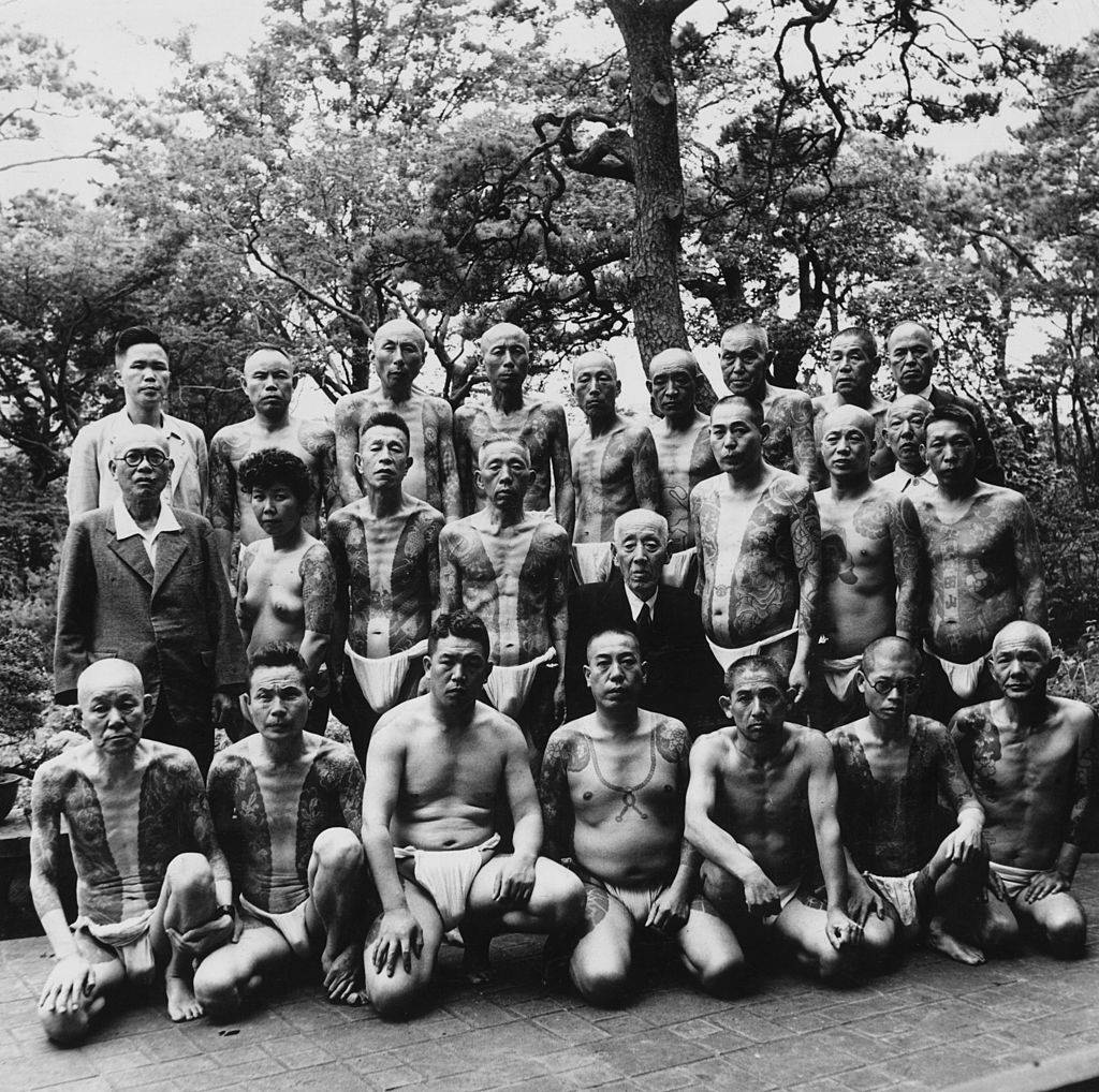 #15 nese gamblers showing their traditional tattoos which reach from shoulder to foot, 1940s
