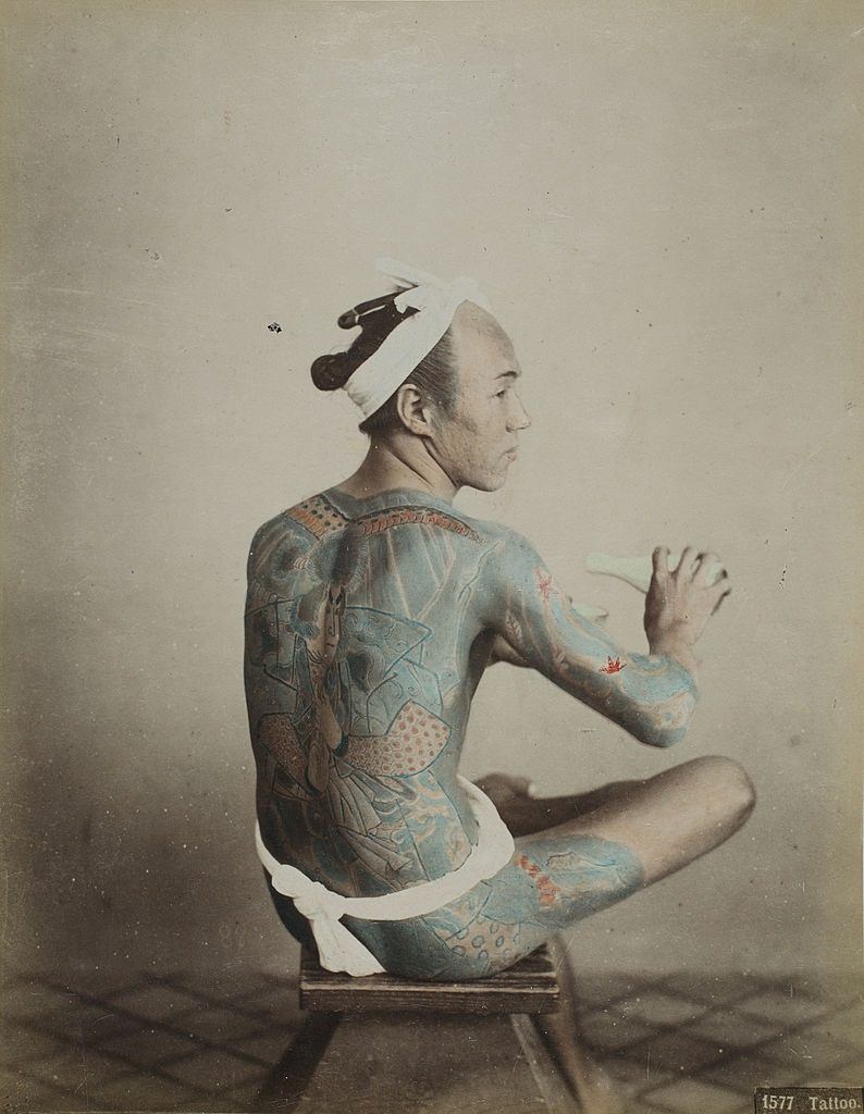 #6 Japanese Tattoo man tattooing himself, 1880s