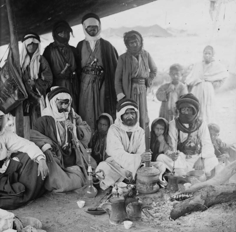 #20 A group of Bedouins prepare coffee in a tent, 1936