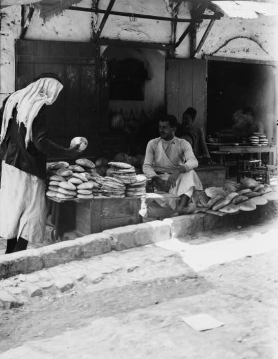#42 A woman barters over the price of bread, Circa 1900-1920