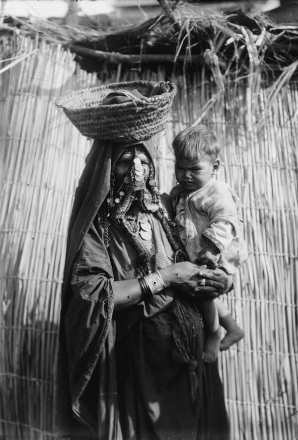 #53 A mother carries her baby.Beersheba, Circa 1900-1920