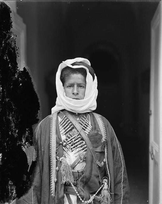 #58 A young Bedouin boy wearing a cartridge belt, Circa 1898-1914