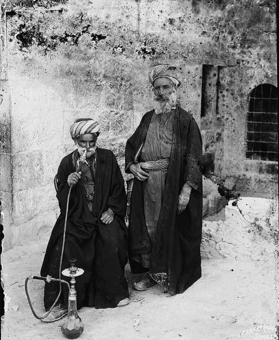 #61 Two men smoke on the streets of Bethlehem, Circa 1900-1920.