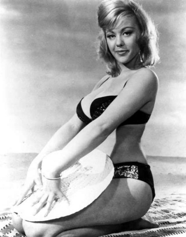 #33 Margaret Nolan posing on the beach