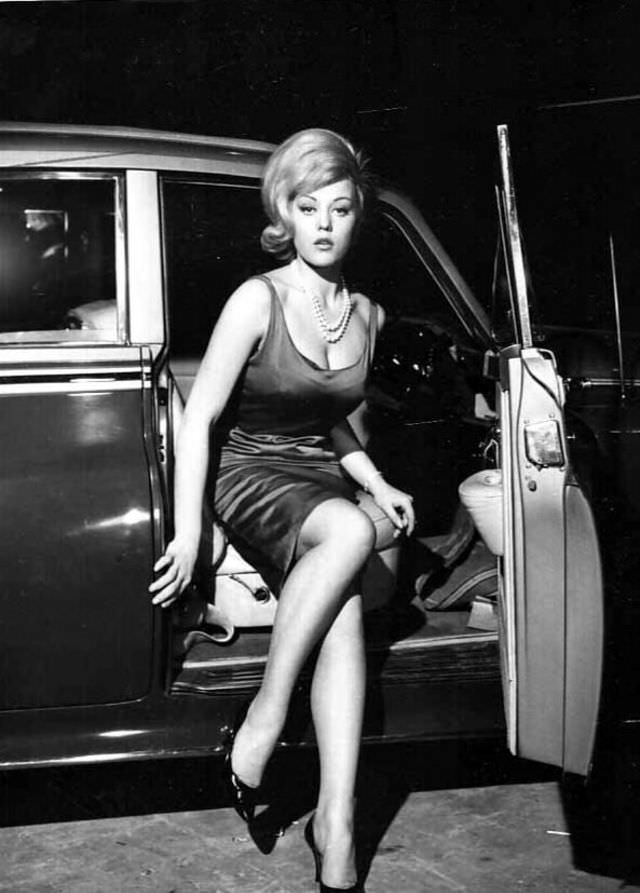#25 Margaret Nolan getting out of a car to attend a party