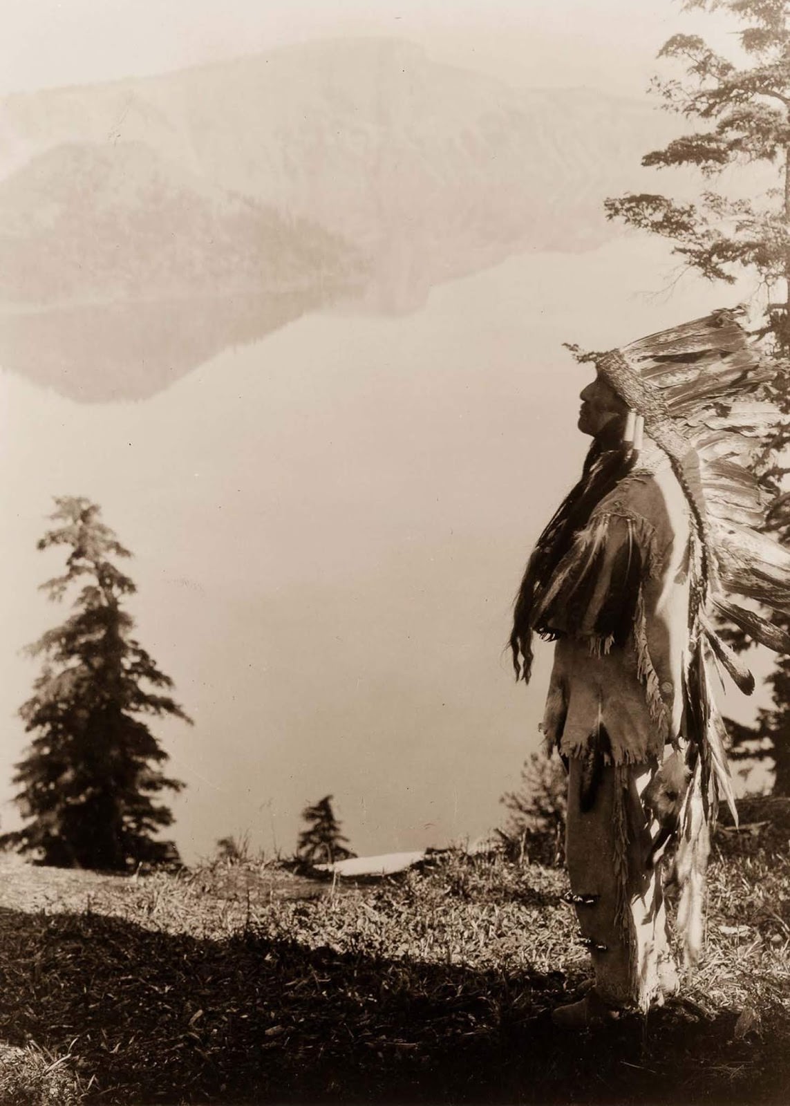 #38 A Klamath chief stands on a hill above Crater Lake, Oregon. 1923.