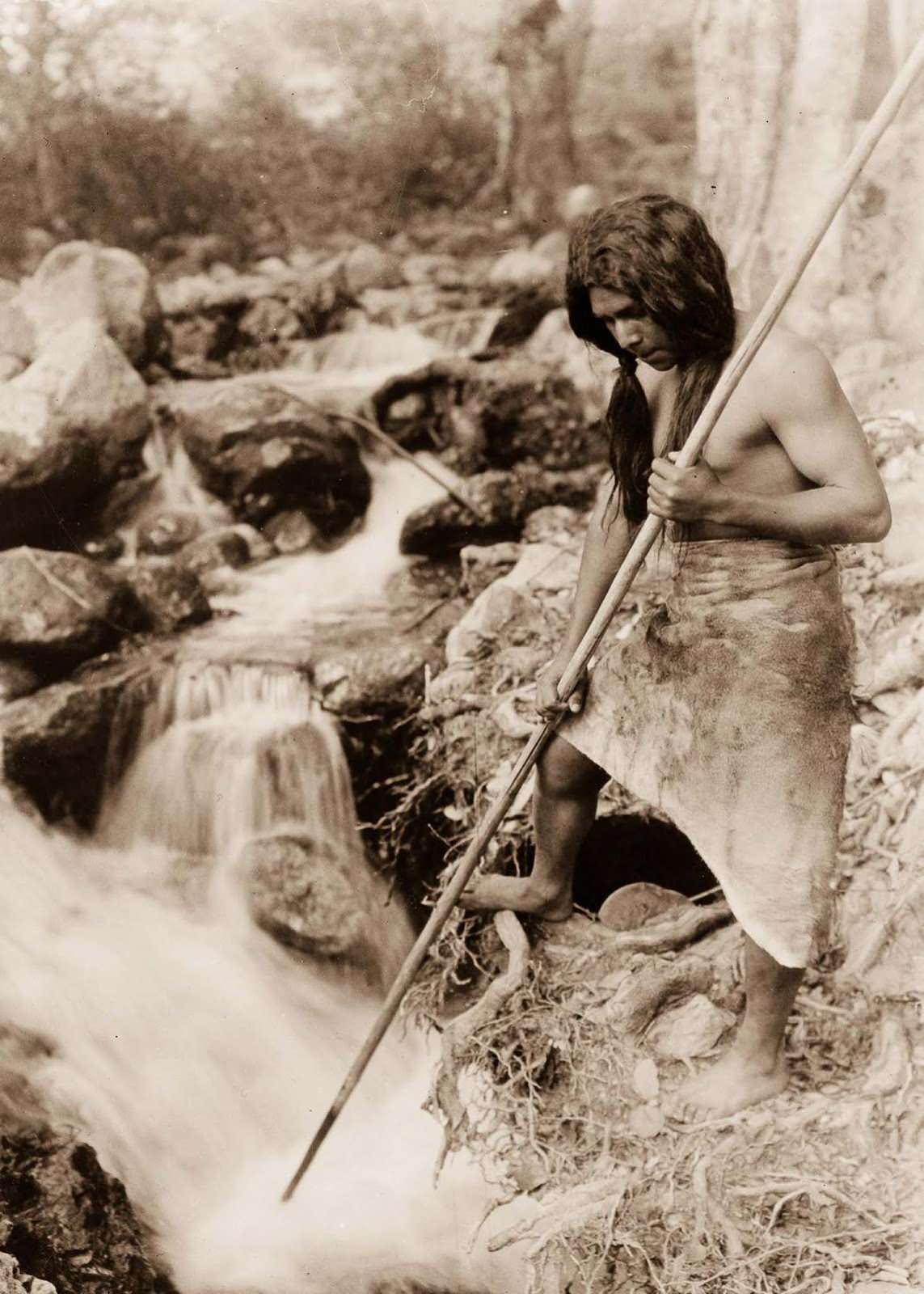 #52 A Hupa spear fisherman watches for salmon. 1923.