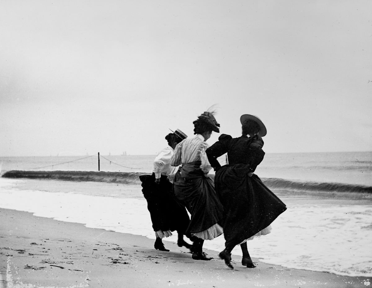 #21 Gertrude Hubbell, Ruth Peters, and Mildred Grimwood play near the water at Arverne, Queens.Sept. 8, 1897