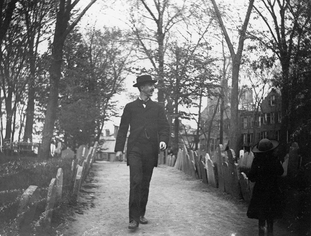 #4 Nathan Abbott and a young girl walk through Copps Hill Cemetery.May 10, 1886