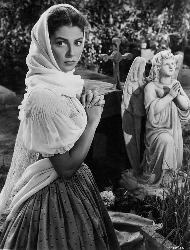 Pier Angeli kneeling before religious statue in a scene from the film ‘Sombrero’, 1953