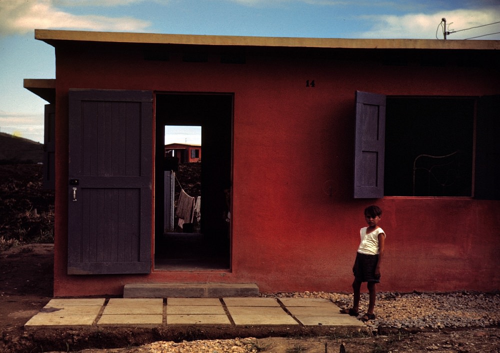 #29 Child of a Farm Security Administration rural rehabilitation borrower in front of his house in Puerto Rico, December 1941
