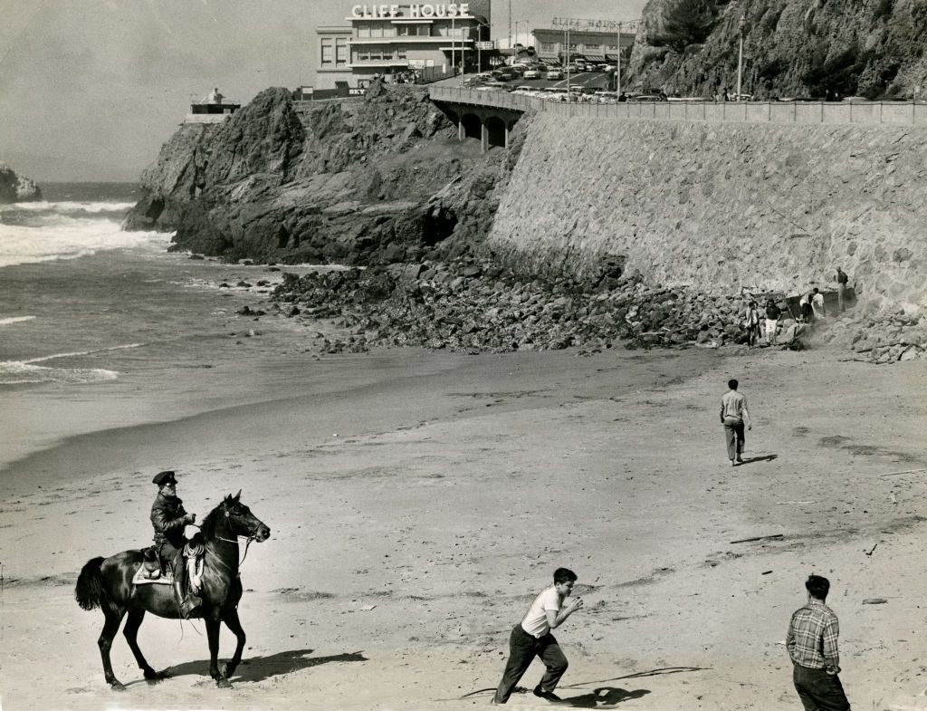 #22 A policeman galloped about the beach chasing bold young men at the Cliff House, 1957