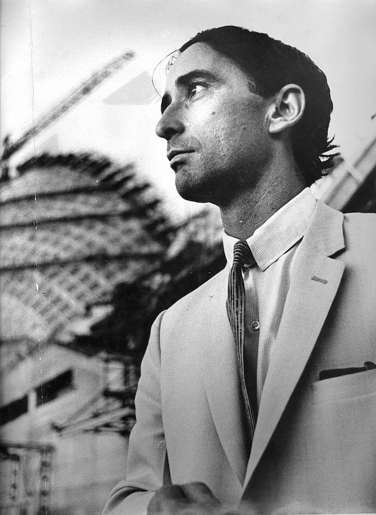 #21 Architect Peter Hall in front of the Sydney Opera House during its construction, 21 April 1966. University of Sydney students armed with posters protest against the architects’ appointments for the Sydney Opera House, 20 April 1966.