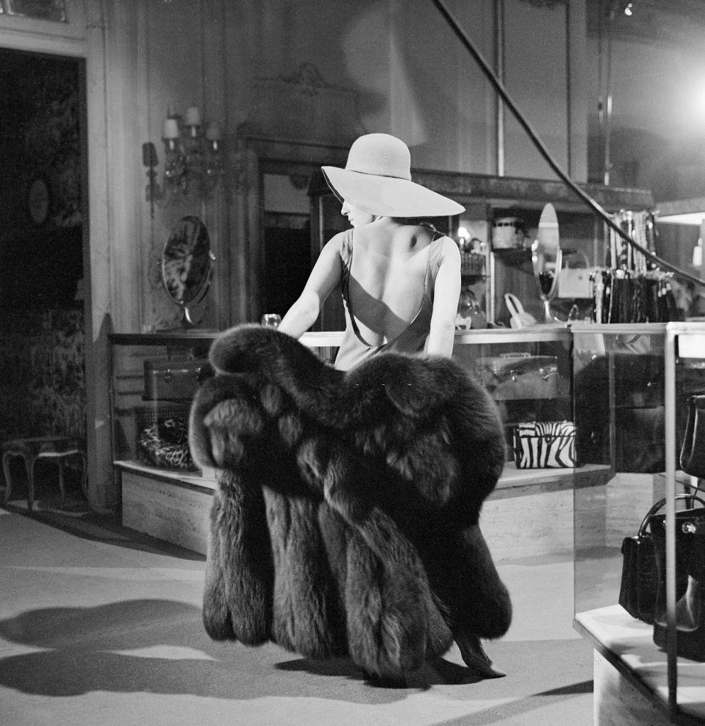 #25 Barbra Streisand tries on a fur coat, 1965