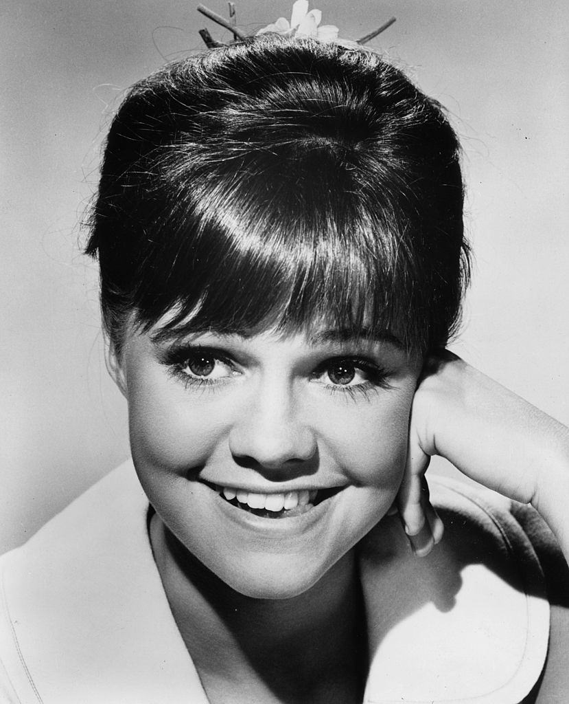 #32 Sally Field smiling with her hand on her cheek, 1965